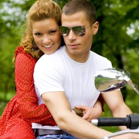 Young couple riding around in the nature.