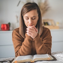 Woman with pray and worship god in her bedroom