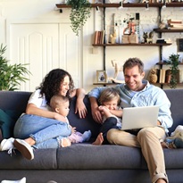 Young beautiful happy family relaxing at home