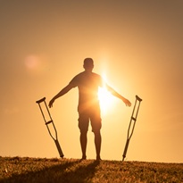 Man with crutches learning to walk again